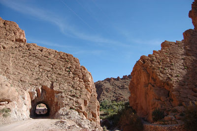 Archway at old ruined building against sky