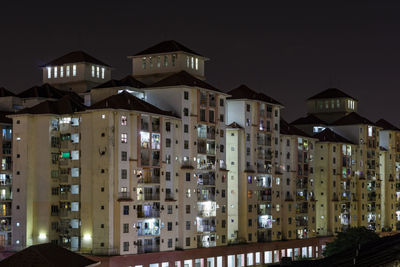 Low angle view of buildings against sky at night