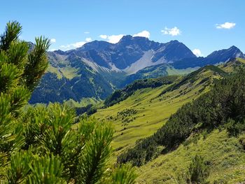 Scenic view of mountains against blue sky