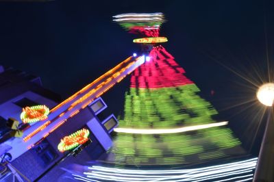 Low angle view of illuminated lights at night