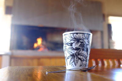 Close-up of burning candles on table