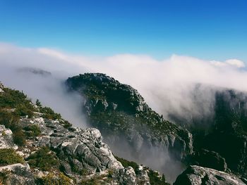 Scenic view of waterfall against sky