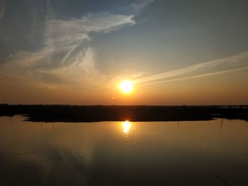 Scenic view of lake against sky during sunset