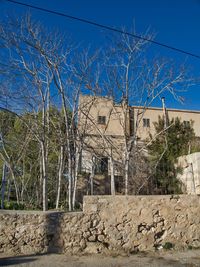 Low angle view of old building against clear blue sky