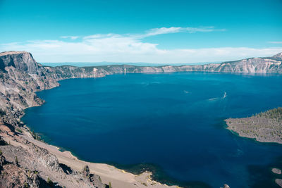 Panoramic view of sea and mountains against sky