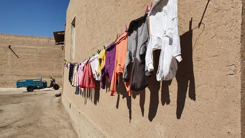 Clothes drying on clothesline against building