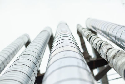 Low angle view of pipes against sky