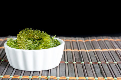 Close-up of vegetables on table against black background