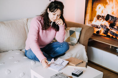 Portrait of young woman using mobile phone