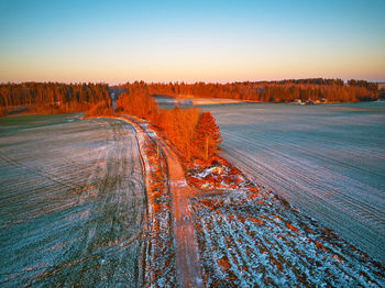 Scenic view of land against sky during sunset