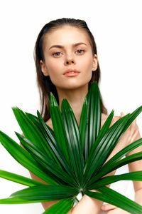 Portrait of young woman against white background