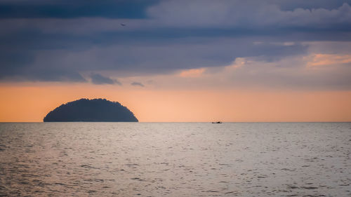 Scenic view of sea against orange sky