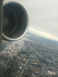 Close-up of airplane on landscape against sky