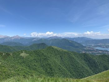 Scenic view of landscape and mountains against blue sky