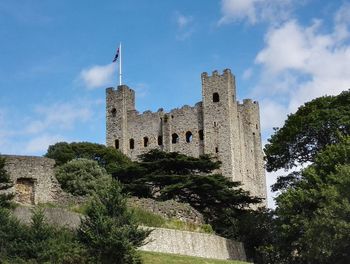 Low angle view of castle against cloudy sky