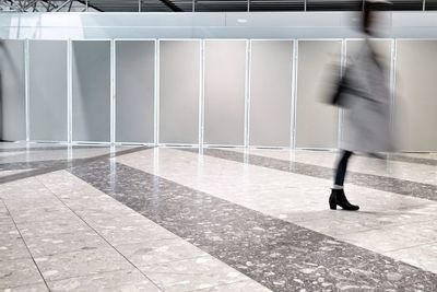 Low section of woman walking in corridor