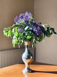 Close-up of flower vase on table at home