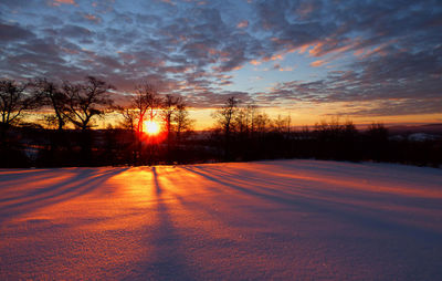 Scenic view of field against sky during sunset