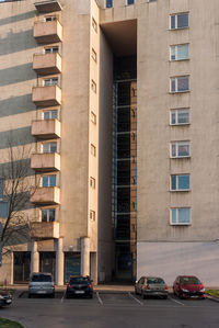 Cars parked on road by buildings in city