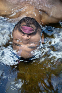 High angle portrait of woman swimming in pool