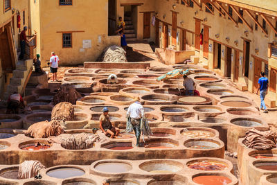 Men dyeing leather in the stone vessels of the tannery