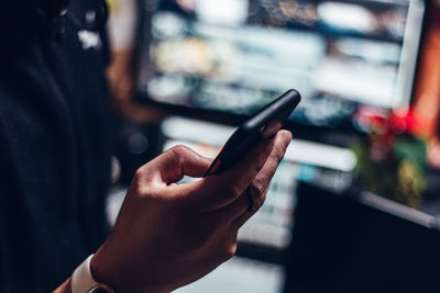 Midsection of man using mobile phone