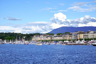 Scenic view of sea by buildings against sky