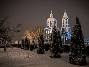 Panoramic view of trees and buildings against sky during winter