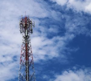 Low angle view of communications tower against sky