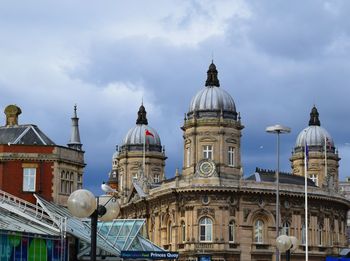 Low angle view of building against cloudy sky