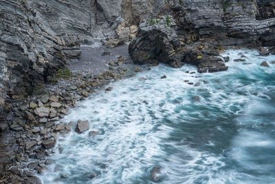 High angle view of river flowing through rocks