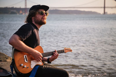 Street musician playing electric guitar in the street