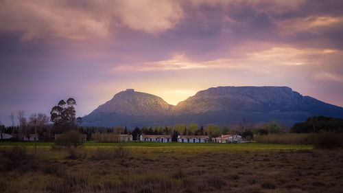 Scenic view of field against sky during sunset