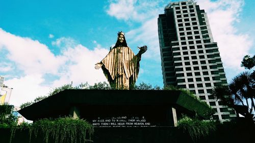 Low angle view of statue against cloudy sky