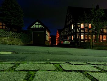 Illuminated house against sky at night