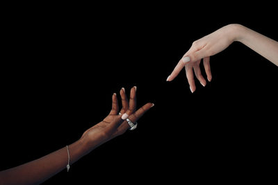 Close-up of hands against black background