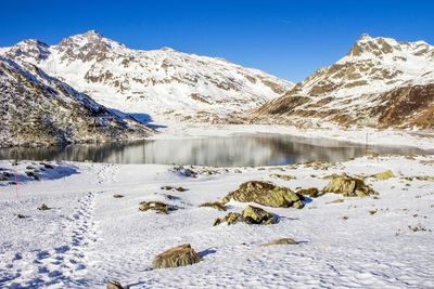 Scenic view of snow covered landscape against sky
