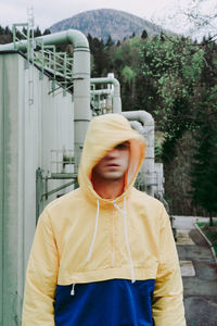 Portrait of man standing against built structure