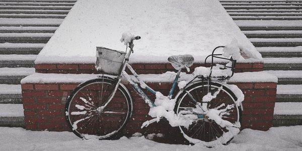 Bicycle parked on snow covered street