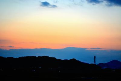 Scenic view of mountains against sky at sunset