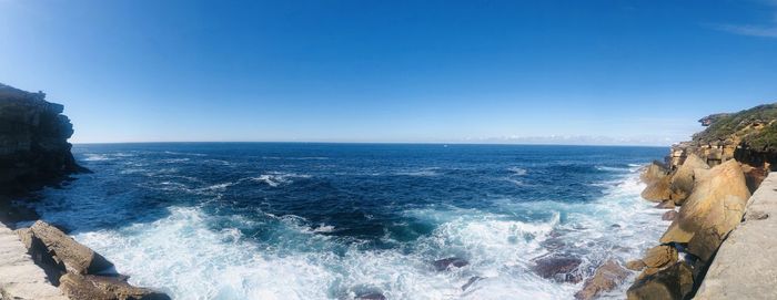 Scenic view of sea against clear blue sky