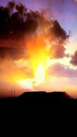 Silhouette of landscape against cloudy sky