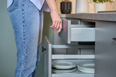 Midsection of woman standing in kitchen