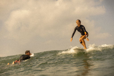 Man surfing in sea against sky