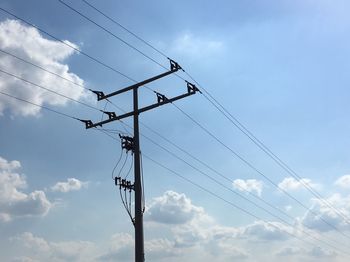 Low angle view of electricity pylon against sky