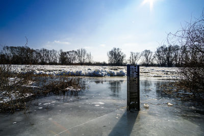 Scenic view of frozen lake against sky during winter