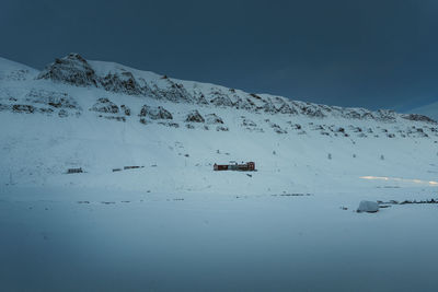 People skiing on snow covered landscape