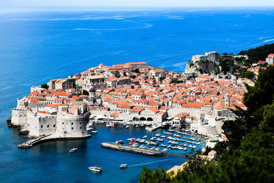 High angle view of townscape by sea