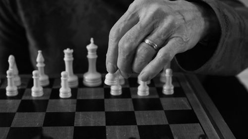 Low angle view of man playing on chess board