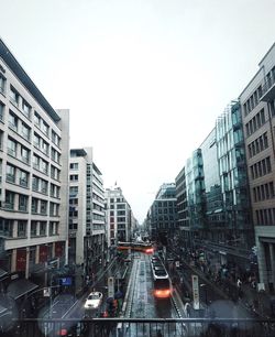 Buildings in city against clear sky